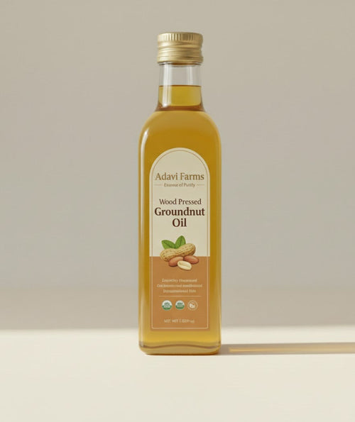 Bottle of Adavi Farms wood pressed groundnut oil on a beige background